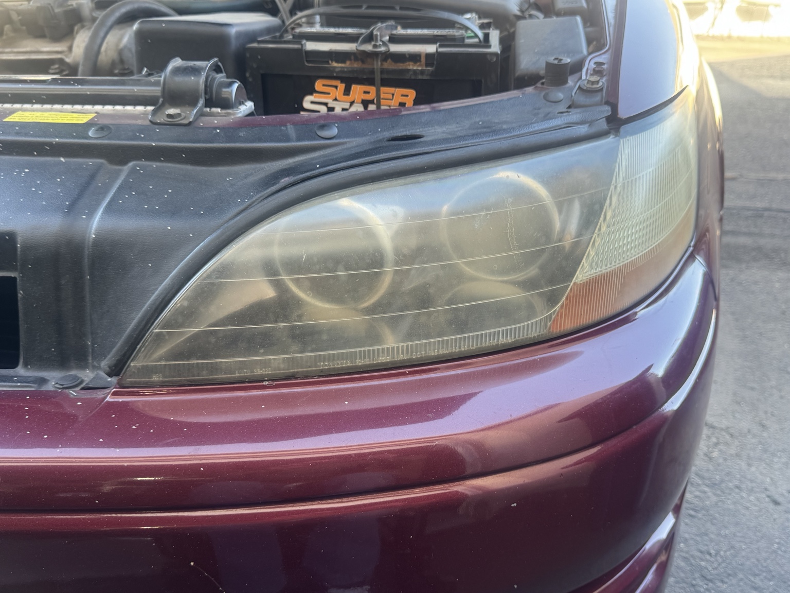 Close up of a cloudy headlight before restoration